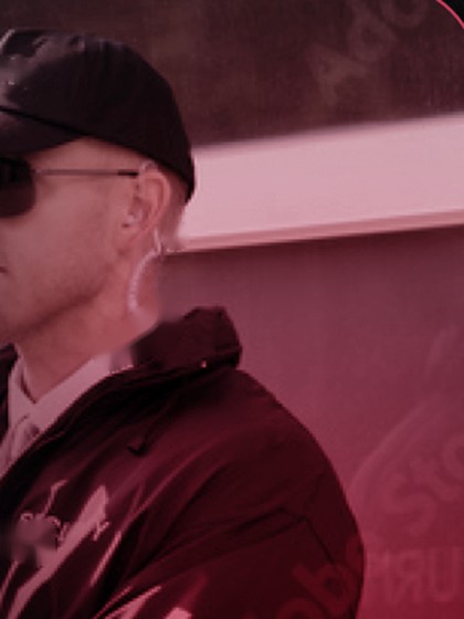 Uniformed Gittings security officer in a SECURITY cap, sunglasses, and radio earpiece