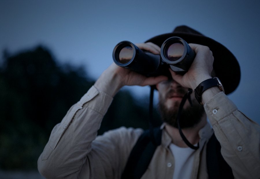 Investigator photographing from a vehicle with a telephoto lens